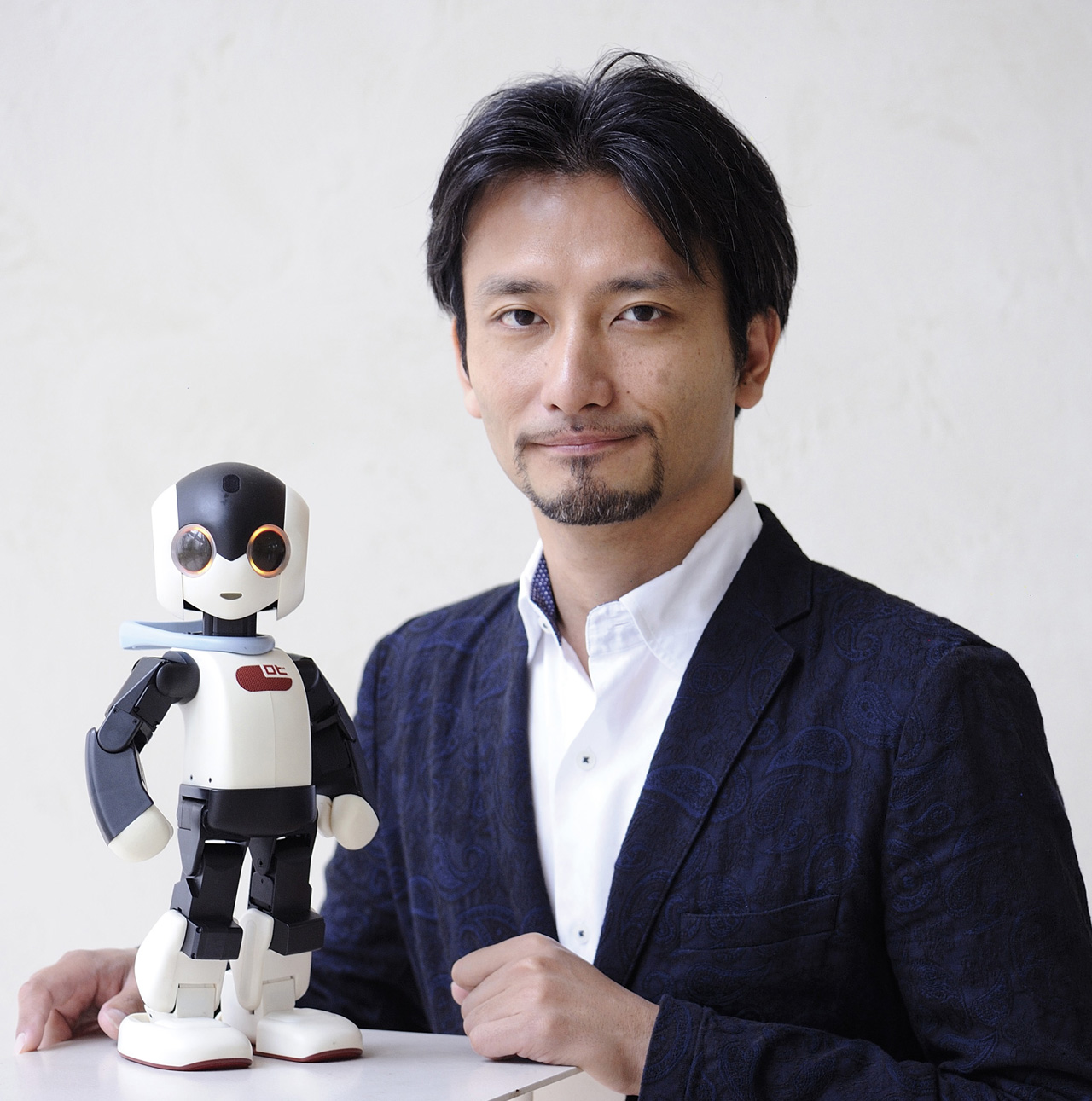 ロビと、ロビをデザイン・設計したロボットクリエイターの高橋智隆さん
