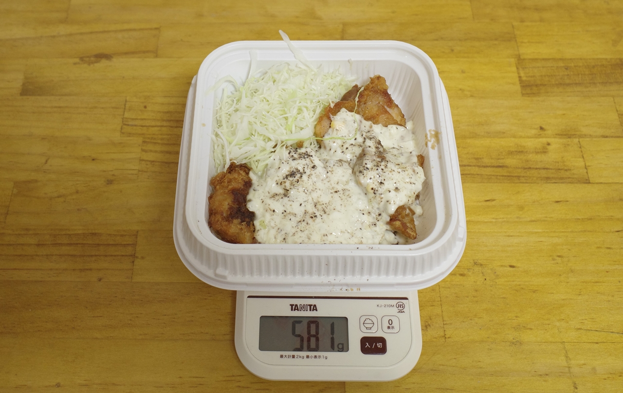 容器込みの「チキンカツとから揚げのタルタル合い盛り弁当」の総重量は581g