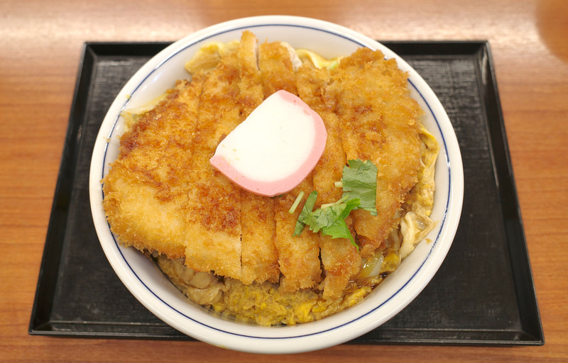 ご飯の上に鶏肉の玉子とじと出汁醤油カツ120g、かまぼこ、三つ葉を盛り付けた「出汁醤油カツ on the 親子丼(竹)」は見た目も豪快!